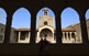 Al pati central del palau dels Reis de Mallorca s'aixeca la capella de la Santa Creu (S. XIV), d'acurada decoració gòtica.